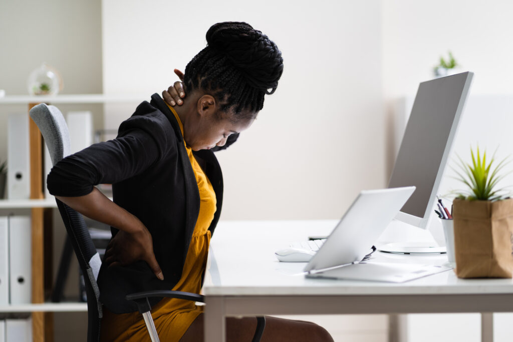 Back Pain Bad Posture Woman Sitting In Office.