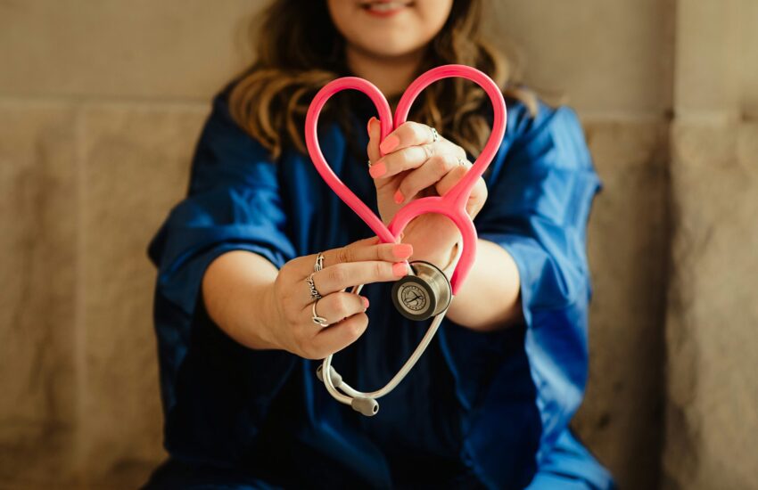lady holding a stethoscope and heart indicating health care