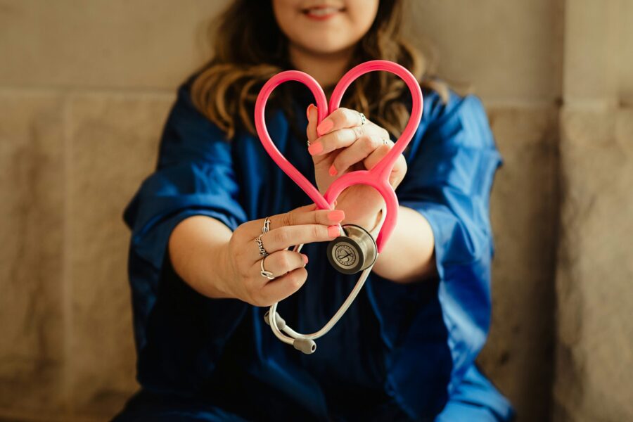 lady holding a stethoscope and heart indicating health care