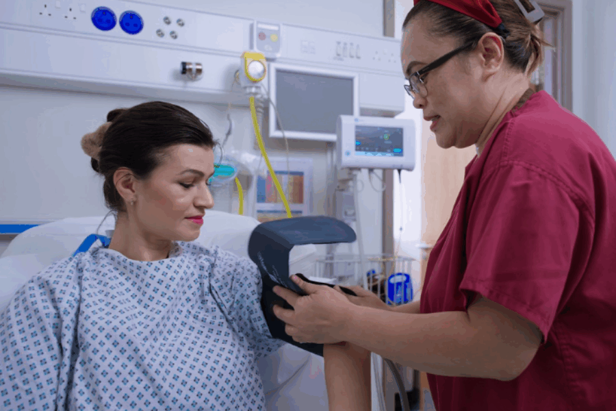 Nurse putting blood pressure band on patient