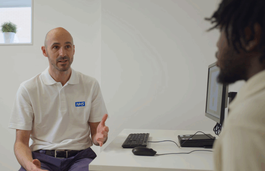 Physio speaking to patient at a desk
