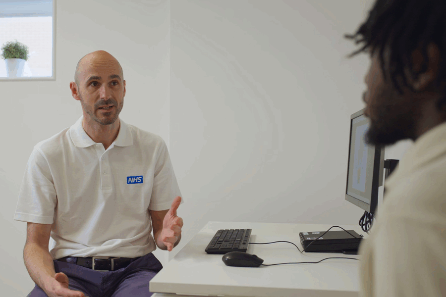 Physio speaking to patient at a desk