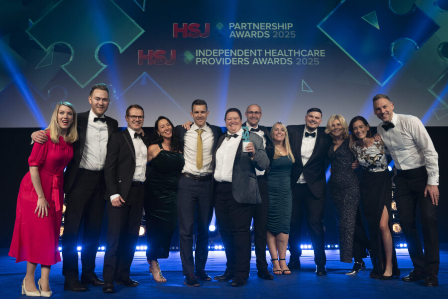 Group shot of Cora team receiving their HSJ award
