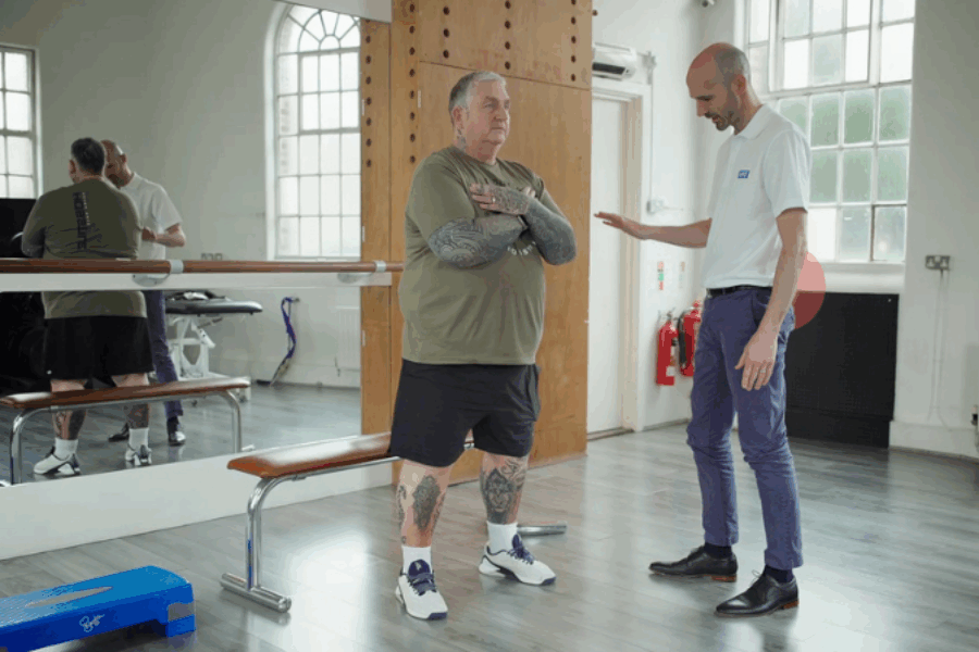 Physio carrying out session with patient in a gym