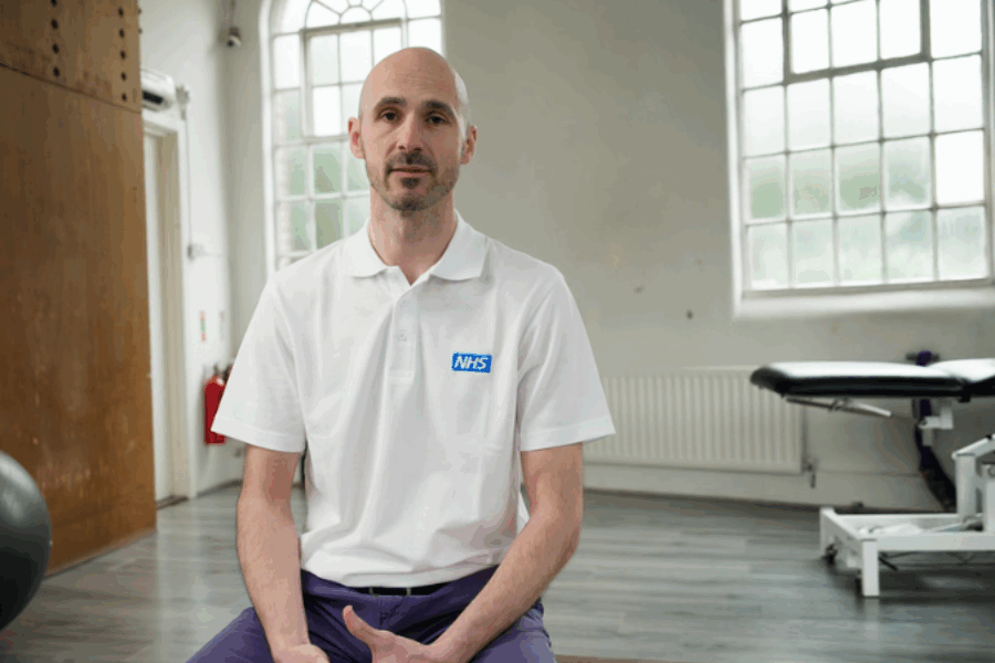 Cora Health physio looking at camera in a gym